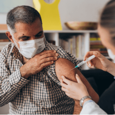 Hispanic Man Receiving Covid 19 vaccine